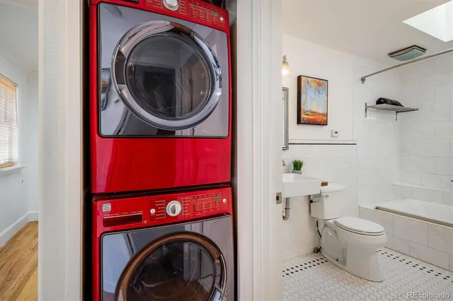 a view of house with wooden fence next to a road