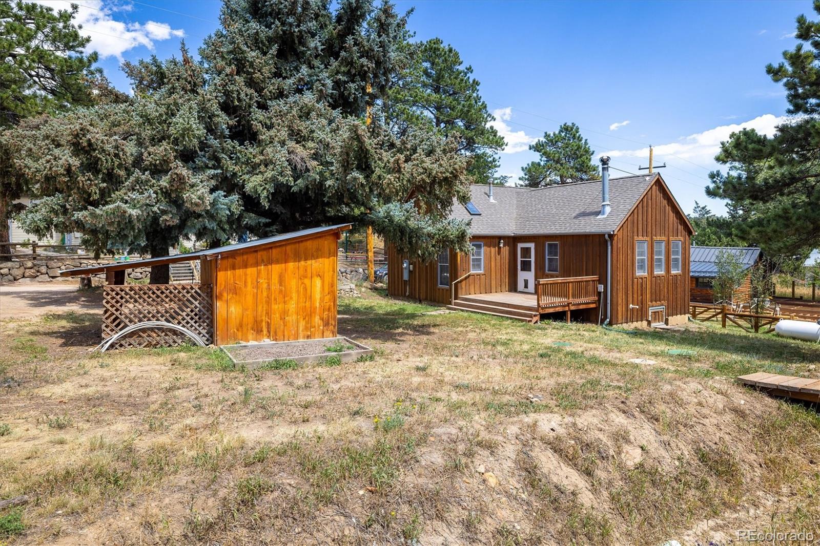855 Main Street Boulder, CO 80302 - Photo 17 of 41 a view of a house with backyard and trees