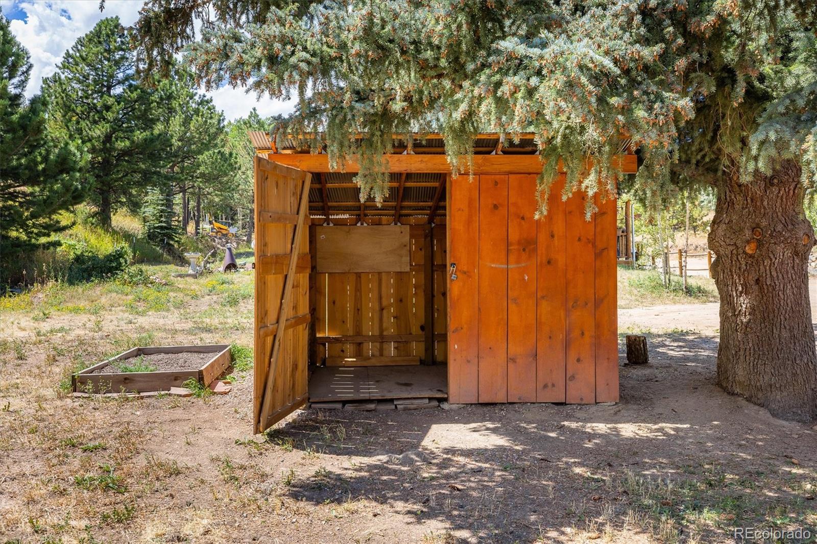 855 Main Street Boulder, CO 80302 - Photo 22 of 41 a backyard of a house with barbeque oven and trees