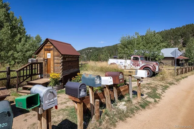 an aerial view of residential houses with outdoor space and trees