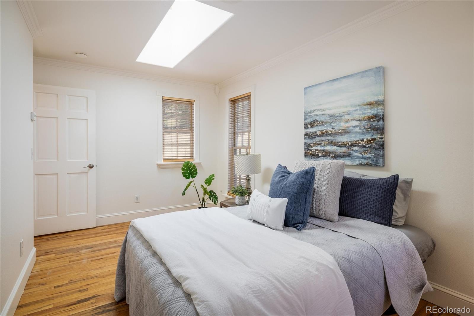 855 Main Street Boulder, CO 80302 - Photo 9 of 41 a bedroom with a bed and a painting on the wall