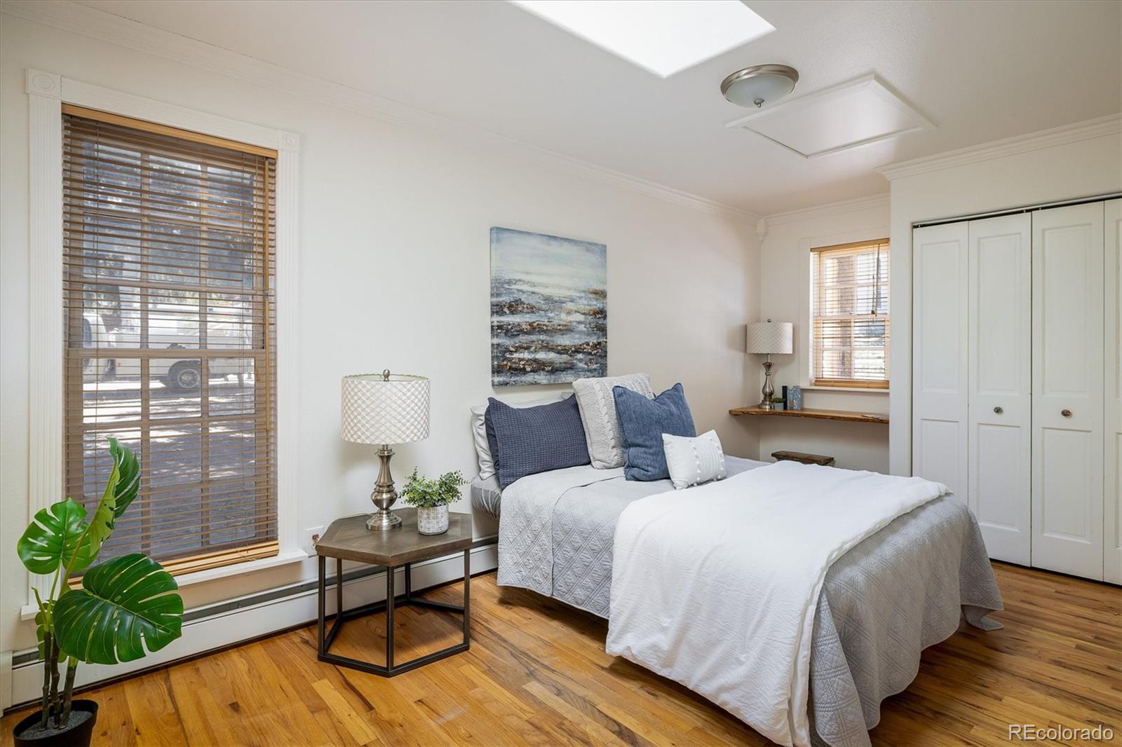 855 Main Street Boulder, CO 80302 - Photo 10 of 41 a bedroom with a bed and a potted plant