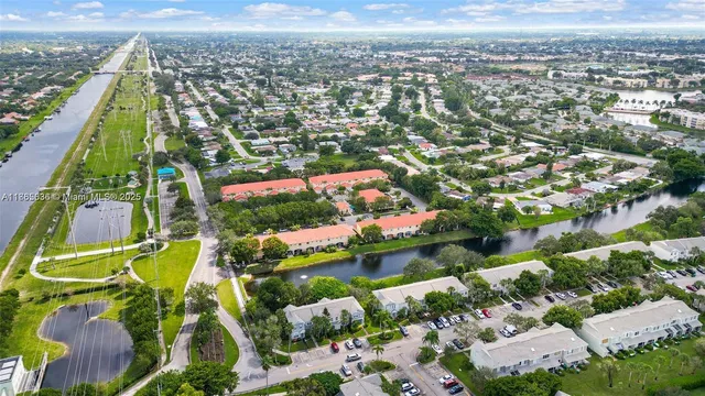 an aerial view of residential houses with outdoor space and swimming pool