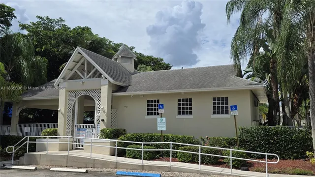 a view of house with yard and swimming pool