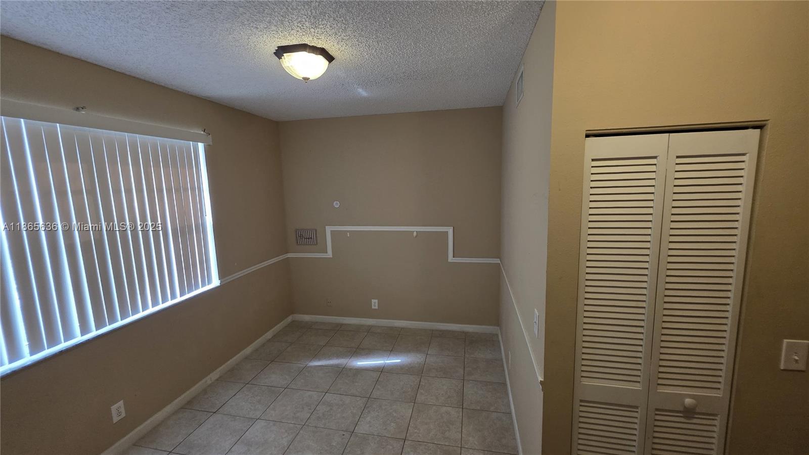 8066 Sanibel Drive, Unit 8066 Tamarac, FL 33321 - Photo 8 of 23 a view of an empty room with a window