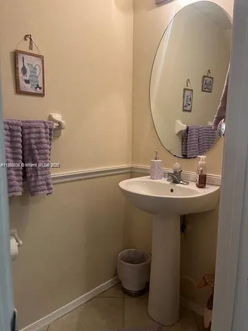 a bathroom with a sink and mirror