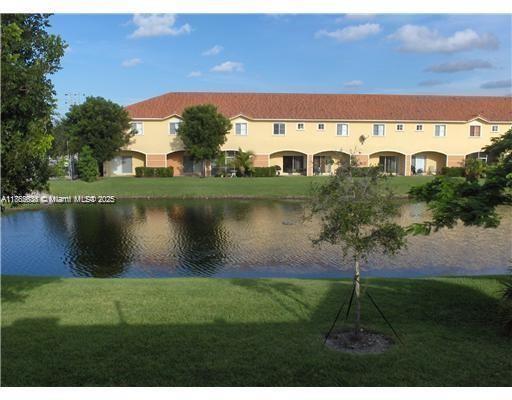 8066 Sanibel Drive, Unit 8066 Tamarac, FL 33321 - Photo 10 of 23 a view of a lake with houses in outdoor space