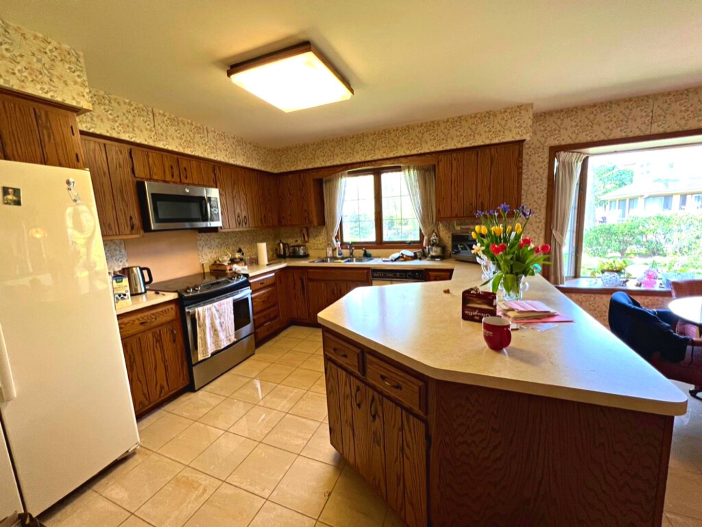910 North Prospect Avenue Park Ridge, IL 60068 - Photo 5 of 18 a kitchen with stainless steel appliances granite countertop a sink counter space and a window