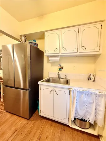 a kitchen with stainless steel appliances granite countertop a refrigerator and a sink