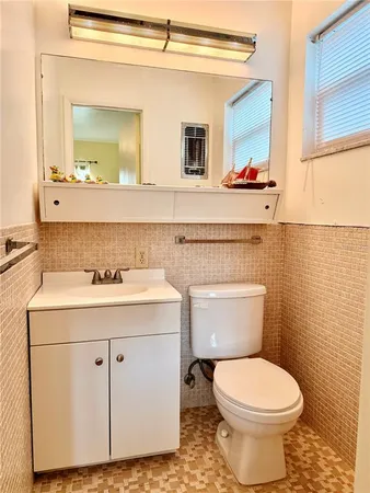 a bathroom with a sink toilet and mirror