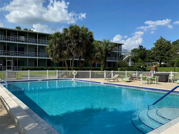 a view of a swimming pool with a yard in back