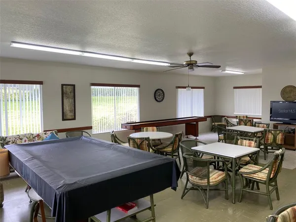 a view of a dining room with furniture and window