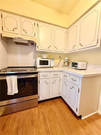 a kitchen with stainless steel appliances granite countertop a sink a stove a microwave and cabinets