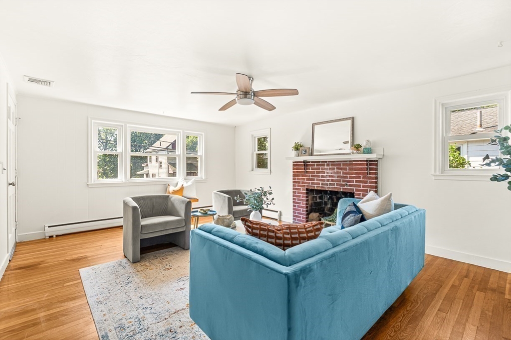 25 Grandview Street Boston, MA 02131 - Photo 4 of 20 a living room with furniture and a fireplace