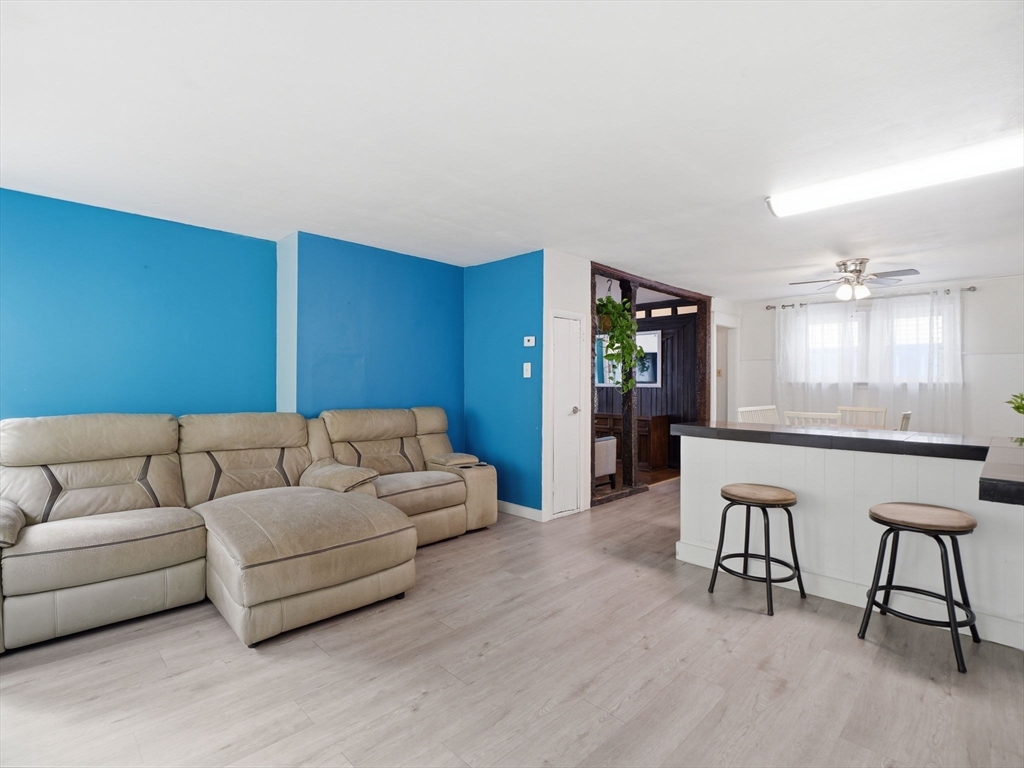 28 Court Street Lowell, MA 01852 - Photo 17 of 42 a living room with furniture and wooden floor