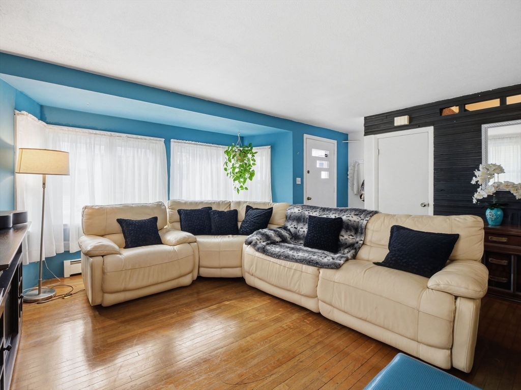 28 Court Street Lowell, MA 01852 - Photo 2 of 42 a living room with furniture and a large window