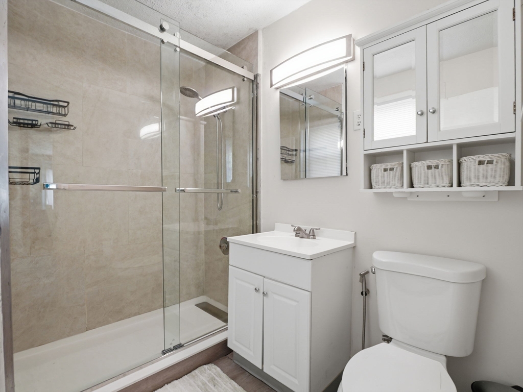 28 Court Street Lowell, MA 01852 - Photo 21 of 42 a bathroom with a toilet a sink and shower