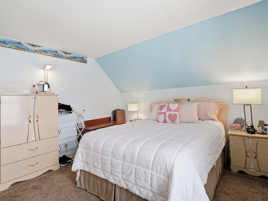 28 Court Street Lowell, MA 01852 - Photo 26 of 42 a bedroom with a bed and a lamp