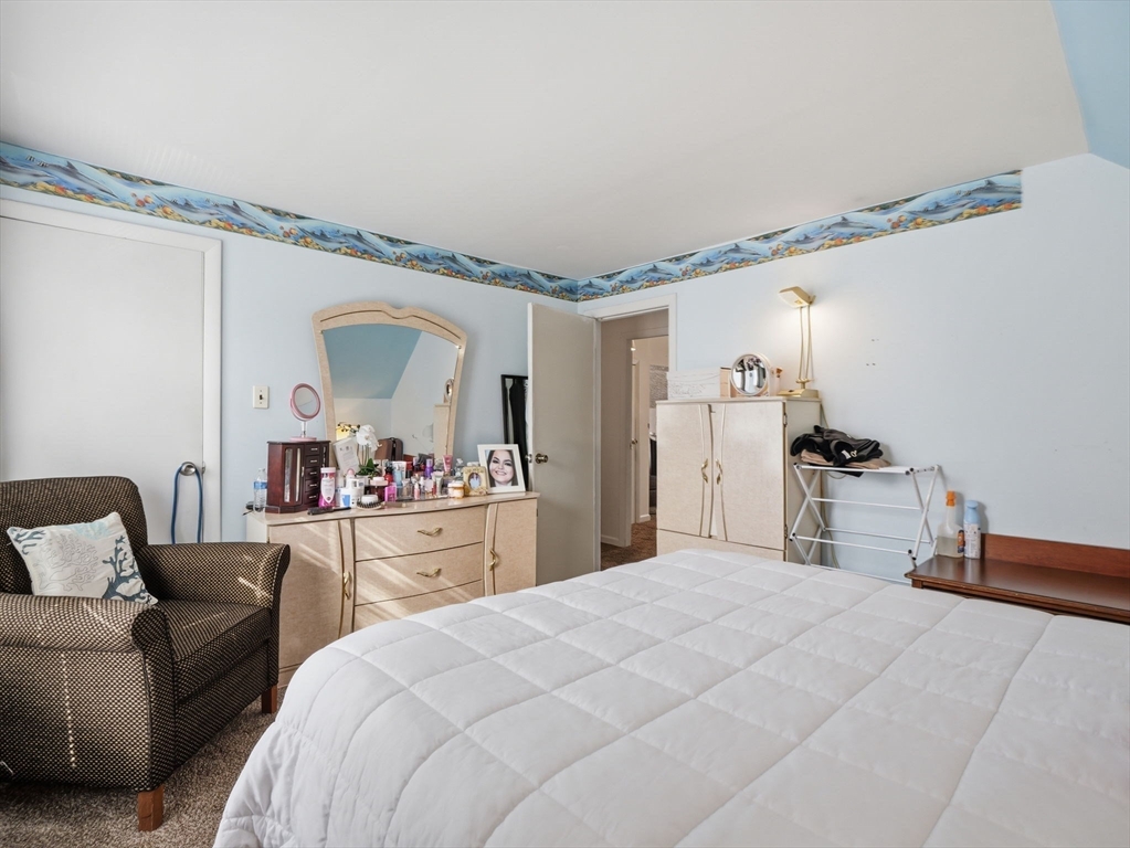 28 Court Street Lowell, MA 01852 - Photo 28 of 42 a bedroom with a bed and a mirror