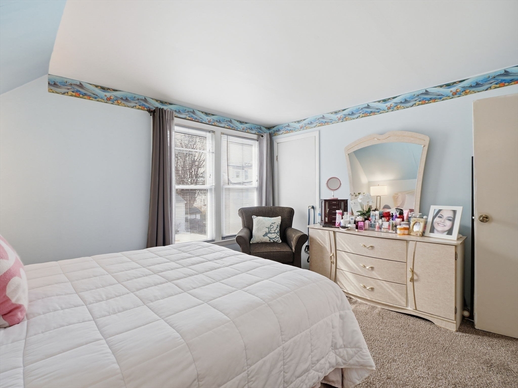 28 Court Street Lowell, MA 01852 - Photo 29 of 42 a bedroom with a bed and a mirror