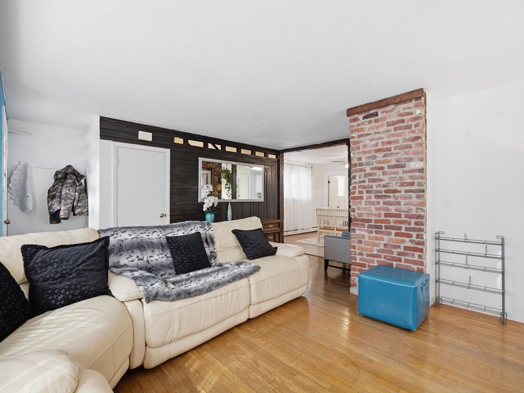 28 Court Street Lowell, MA 01852 - Photo 3 of 42 a living room with furniture and a wooden floor