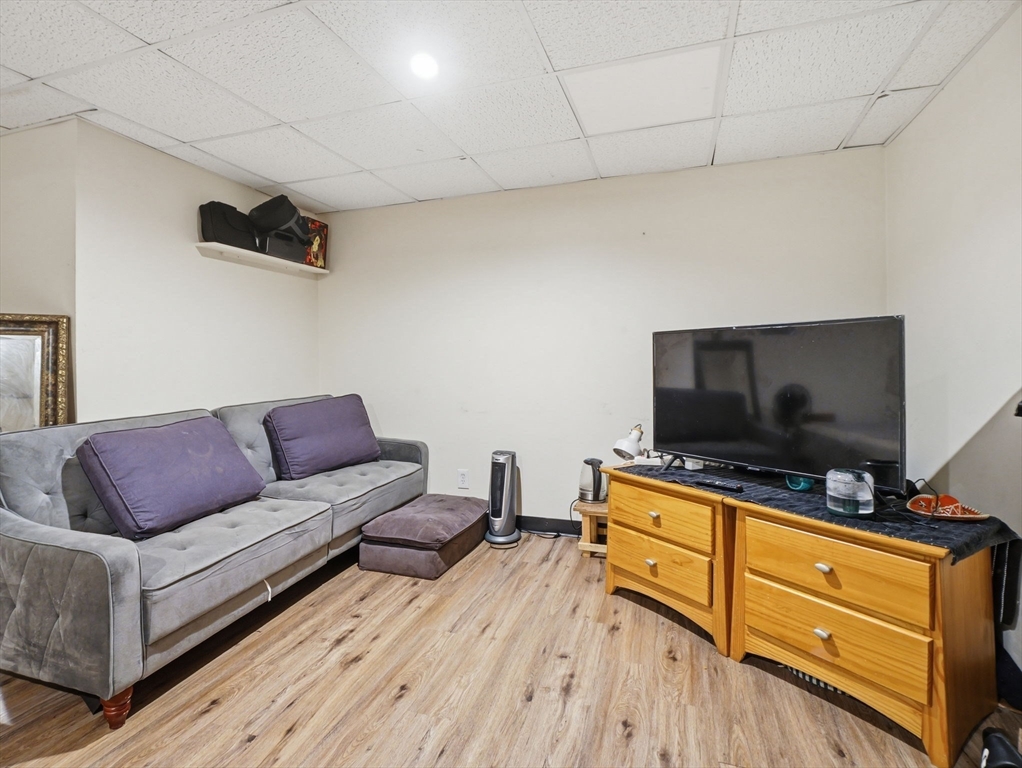 28 Court Street Lowell, MA 01852 - Photo 34 of 42 a living room with furniture and a flat screen tv