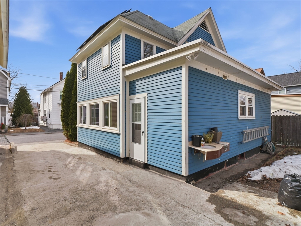 28 Court Street Lowell, MA 01852 - Photo 41 of 42 a view of house with a yard and parking space