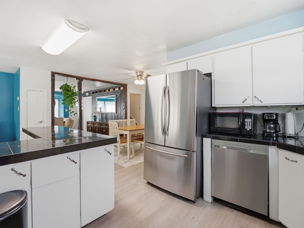 28 Court Street Lowell, MA 01852 - Photo 9 of 42 a kitchen with stainless steel appliances a refrigerator and a sink