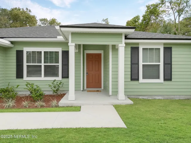 a front view of a house with garden