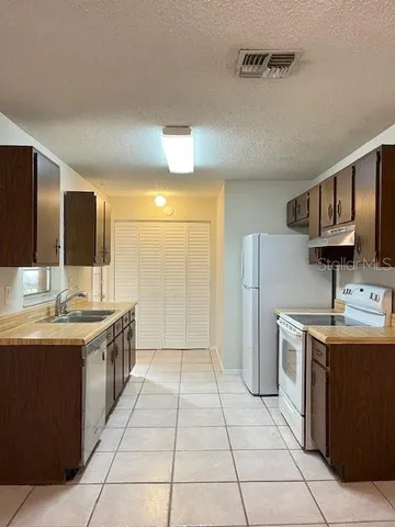 a kitchen with a sink and a refrigerator