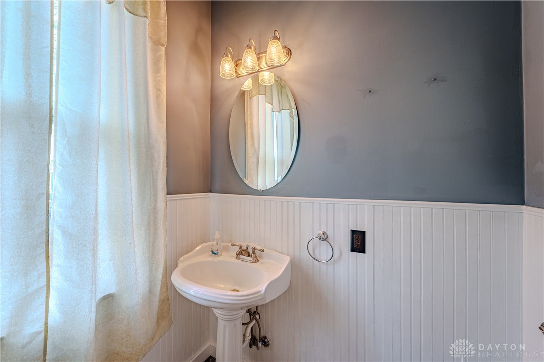308 Yankee Road Middletown, OH 45044 - Photo 23 of 47 A well-appointed bathroom with a classic pedestal sink and ample lighting.