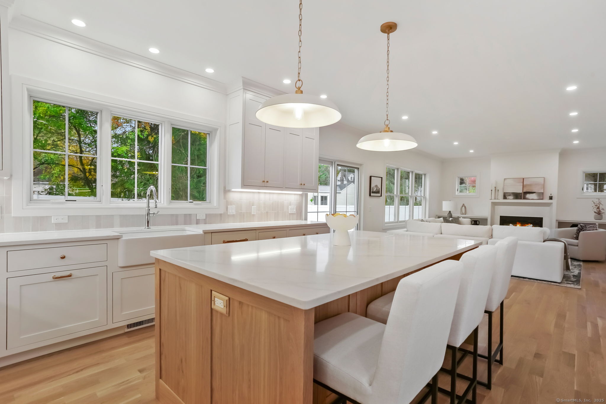 45 Robin Circle Fairfield, CT 06824 - Photo 13 of 40 a kitchen with a stove a sink a dining table and chairs