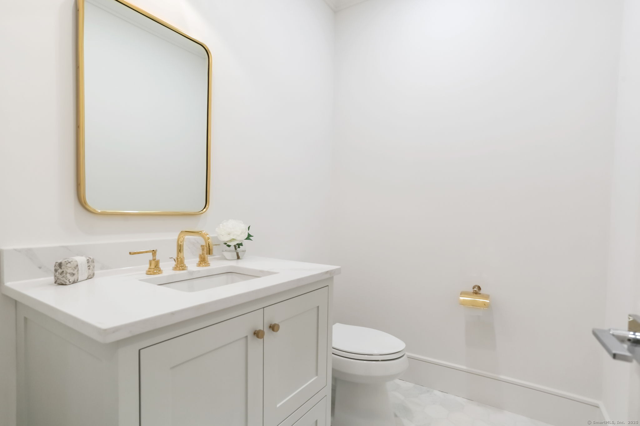 45 Robin Circle Fairfield, CT 06824 - Photo 17 of 40 a bathroom with a sink a toilet and mirror