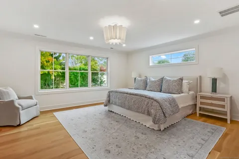 a spacious bedroom with a bed and a couch