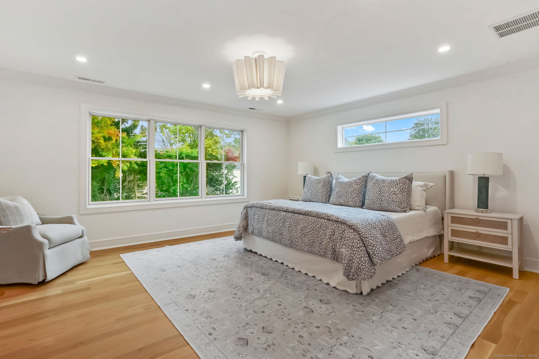 45 Robin Circle Fairfield, CT 06824 - Photo 19 of 40 a spacious bedroom with a bed and a couch