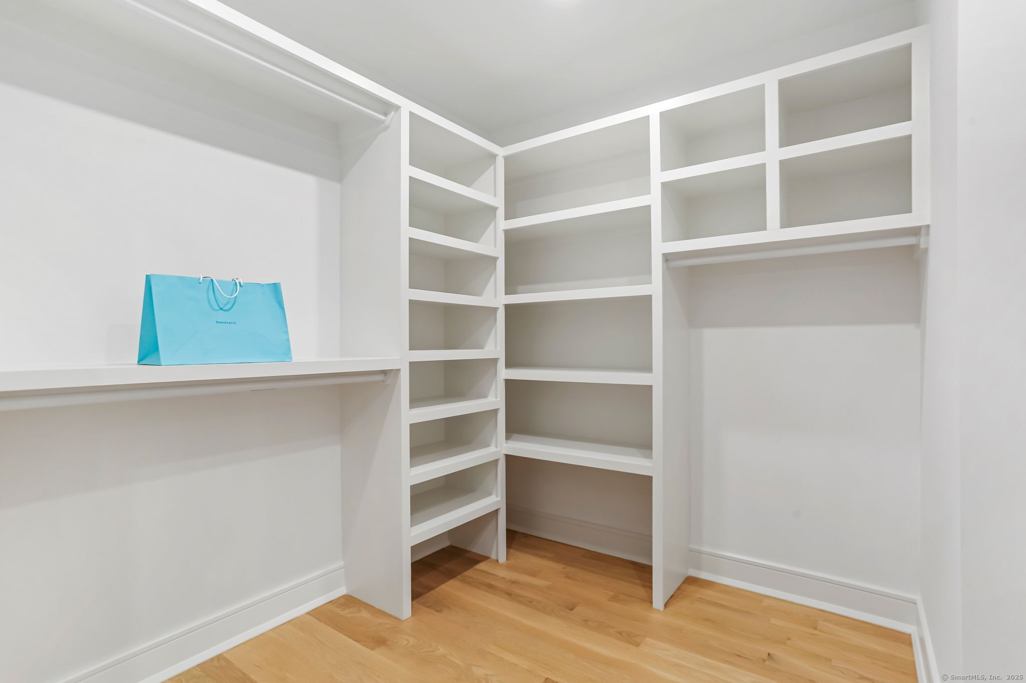 45 Robin Circle Fairfield, CT 06824 - Photo 21 of 40 a view of walk in closet with empty racks