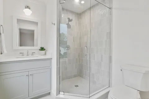 a bathroom with a shower a sink and mirror