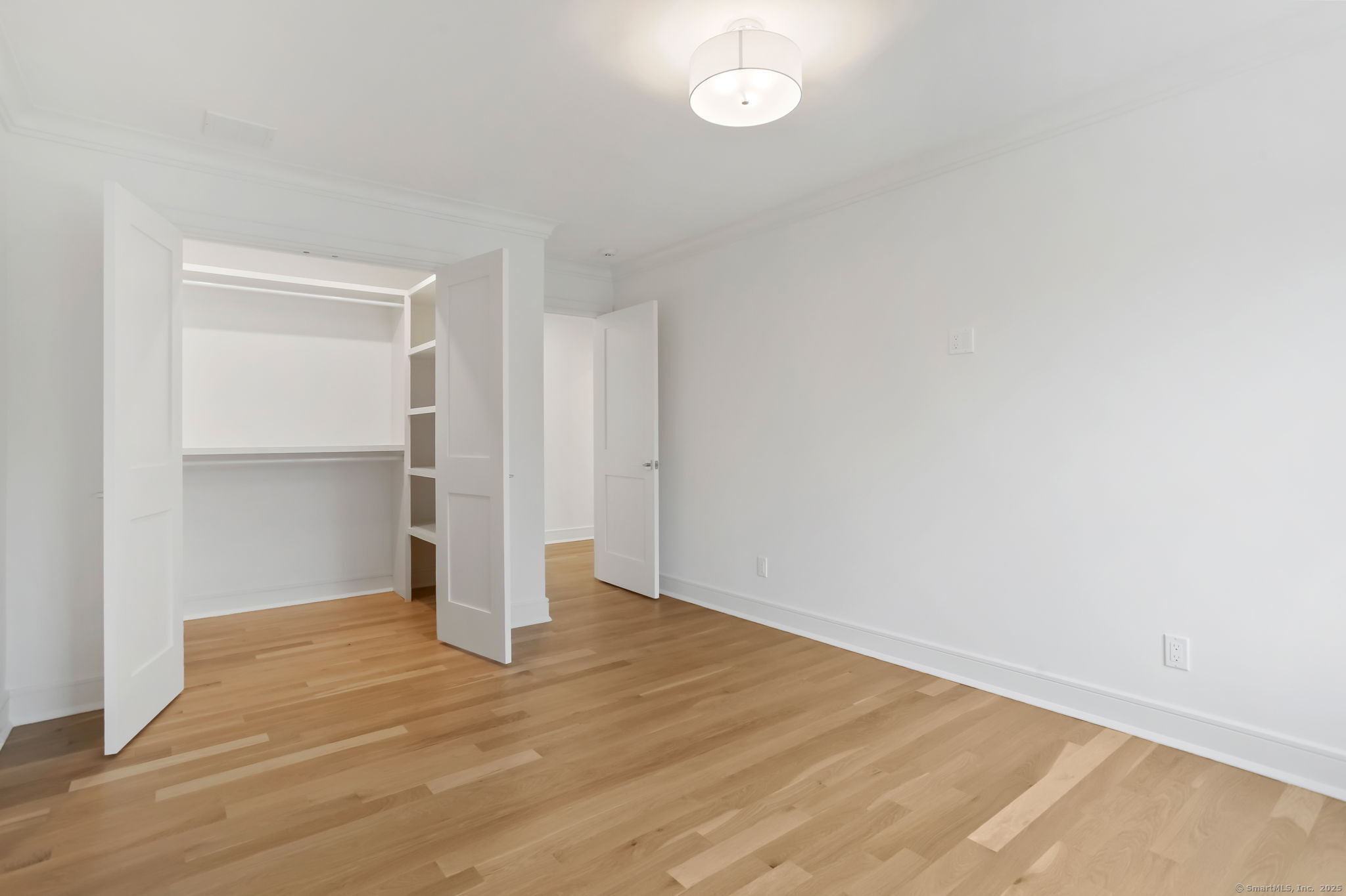 45 Robin Circle Fairfield, CT 06824 - Photo 29 of 40 a view of empty room with wooden floor