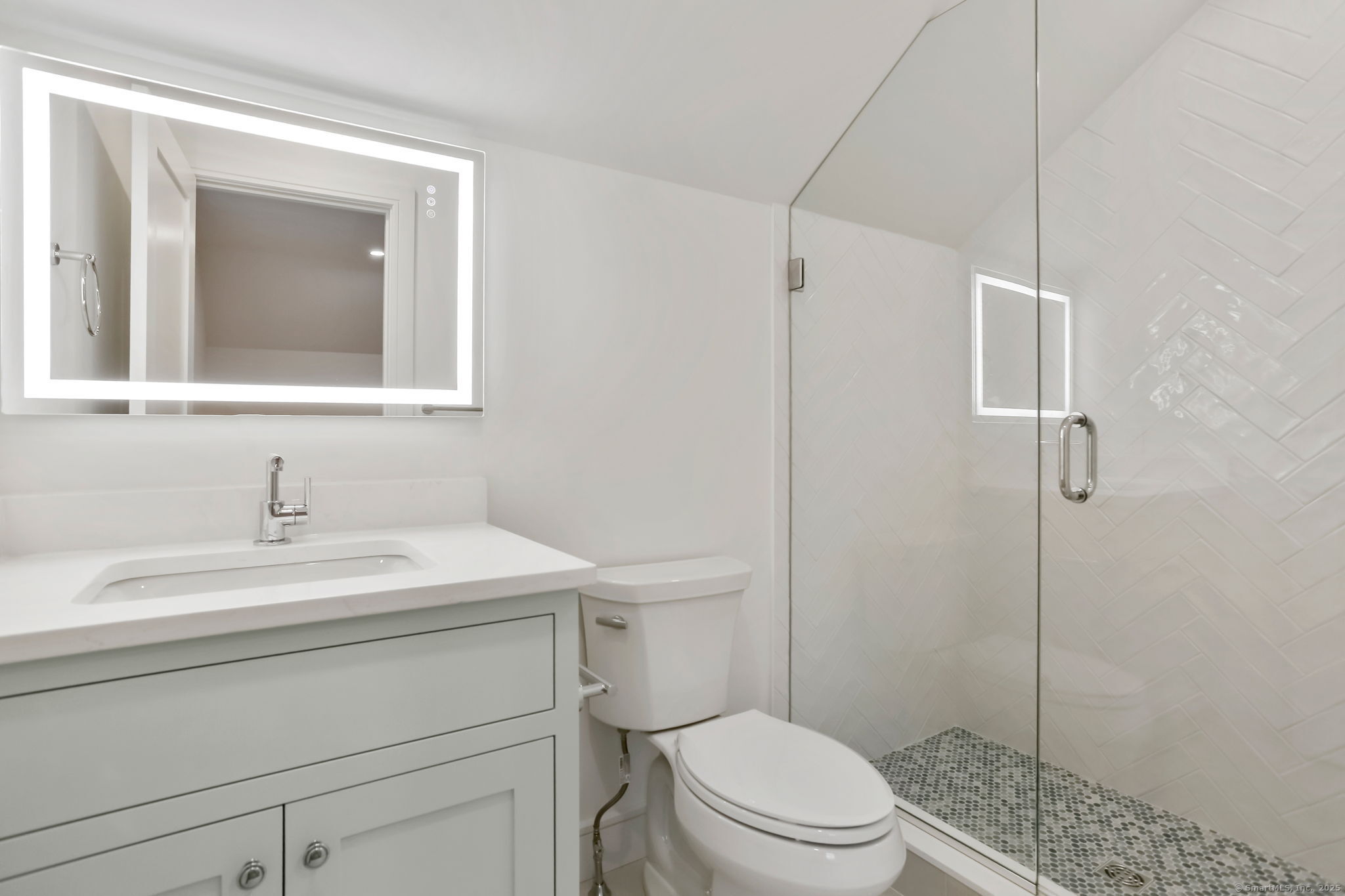 45 Robin Circle Fairfield, CT 06824 - Photo 34 of 40 a bathroom with a sink toilet vanity and shower