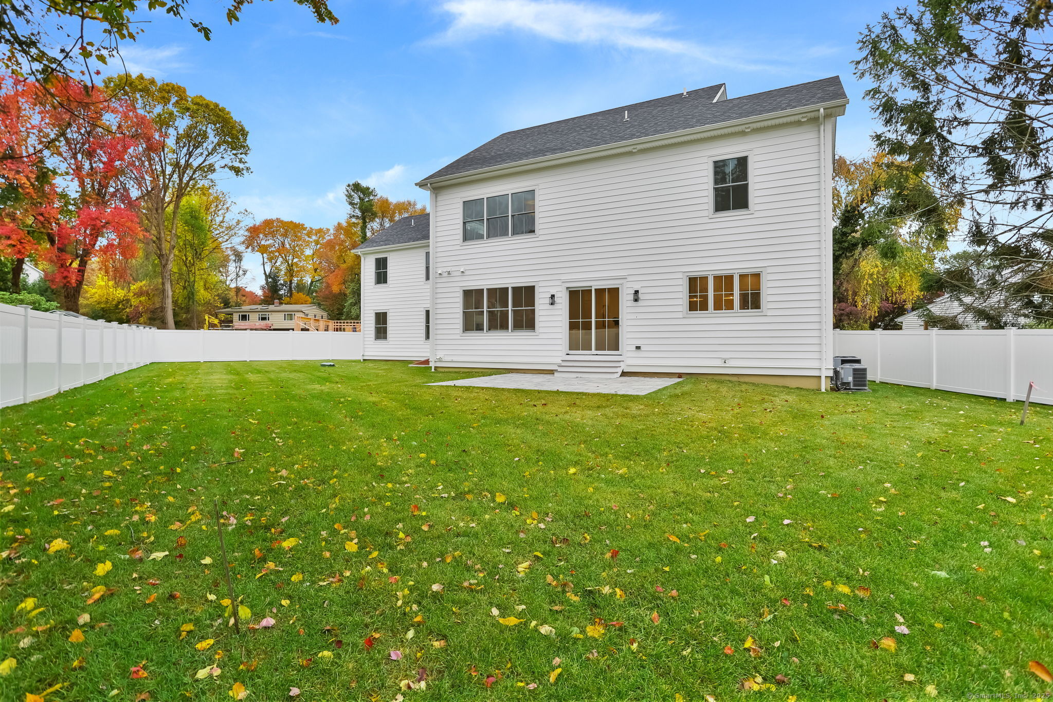 45 Robin Circle Fairfield, CT 06824 - Photo 36 of 40 a front view of house with yard and trees in the background