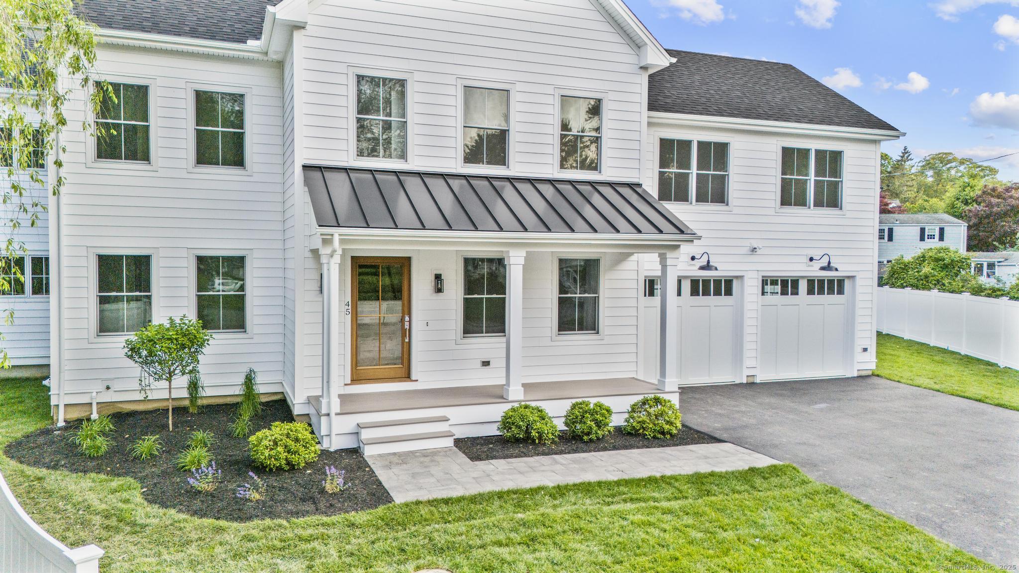 45 Robin Circle Fairfield, CT 06824 - Photo 39 of 40 a front view of a house with a yard and potted plants