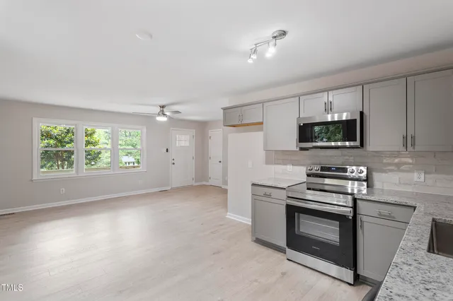 a kitchen with a stove and a microwave