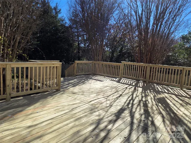 a view of balcony with wooden floor and fence
