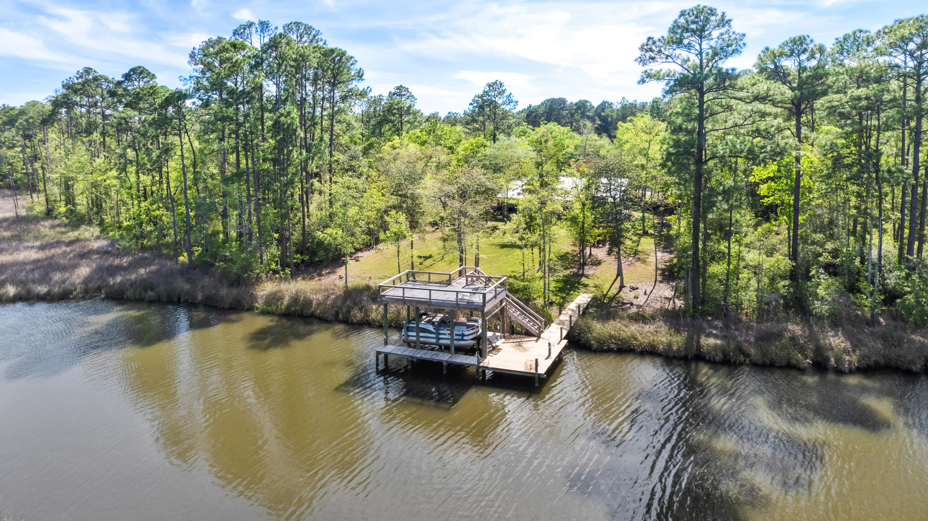 528 Bay Grove Road Freeport, FL 32439 - Photo 62 of 68 a view of a lake with boats and trees in the background