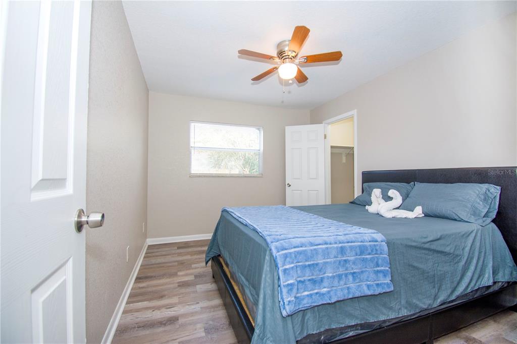1504 Hallam Drive Lakeland, FL 33813 - Photo 11 of 34 a bedroom with a bed and a chandelier