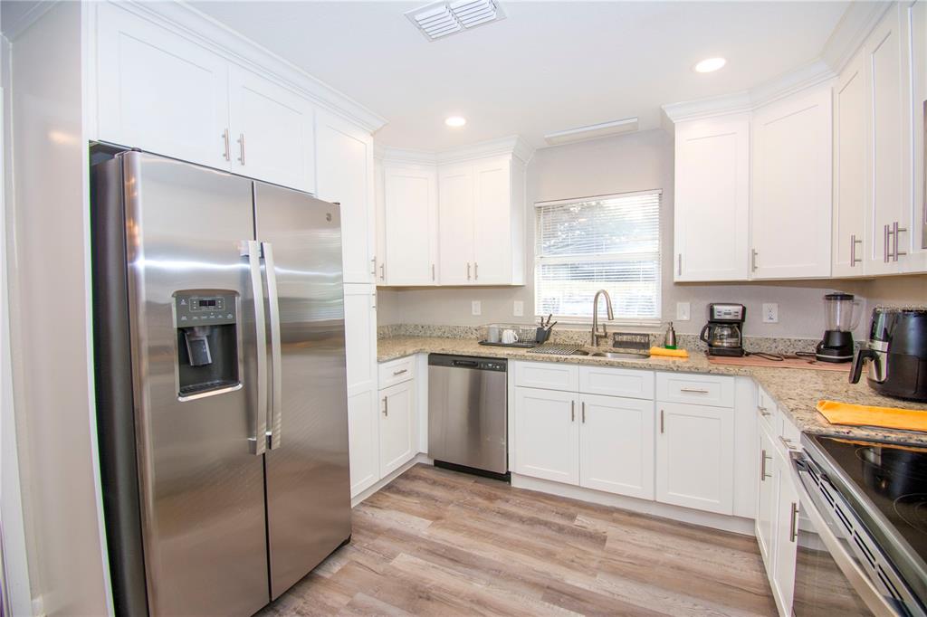 1504 Hallam Drive Lakeland, FL 33813 - Photo 15 of 34 a kitchen with a refrigerator sink and stove top oven