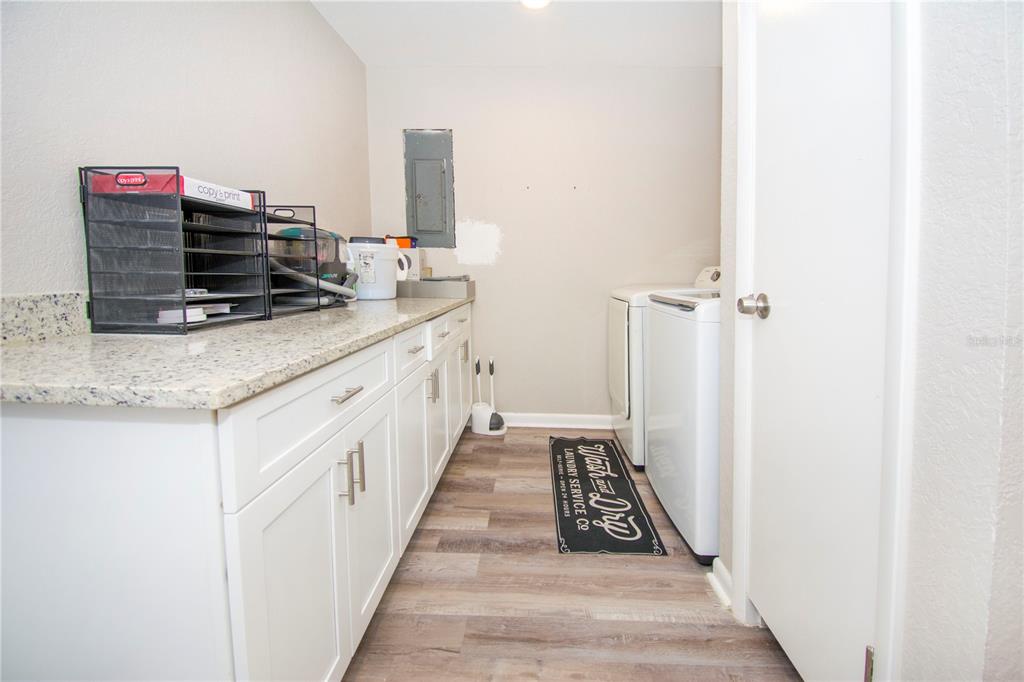 1504 Hallam Drive Lakeland, FL 33813 - Photo 18 of 34 a kitchen with sink stove and cabinets
