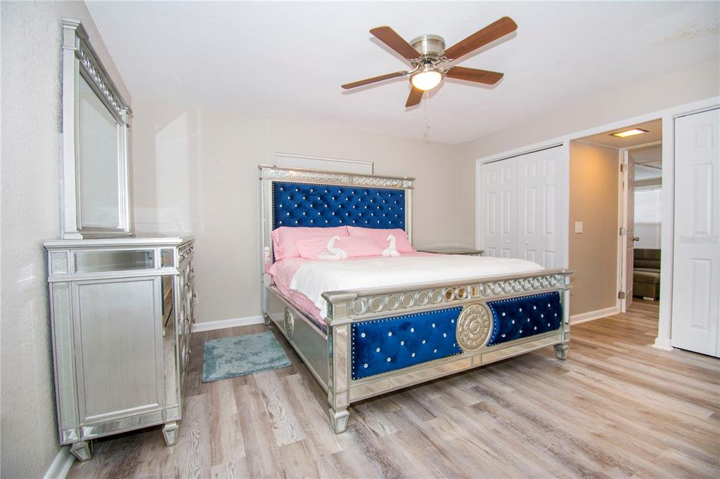 1504 Hallam Drive Lakeland, FL 33813 - Photo 20 of 34 a bedroom with a bed and a chandelier