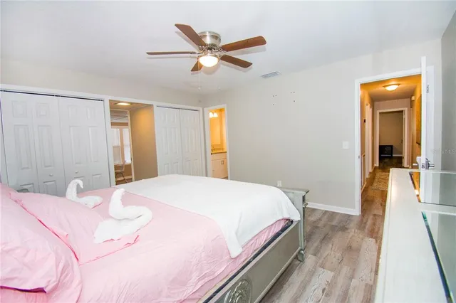 a bedroom with a large bed and a chandelier