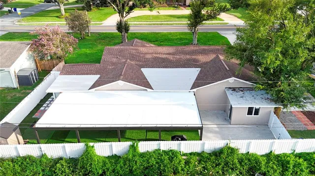 an aerial view of a house with a yard